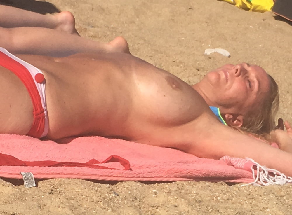 Dazzling blonde topless beach voyeur