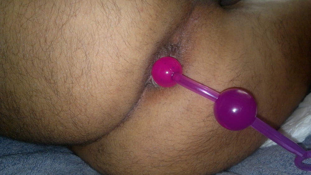 Anal beads while stroking dick