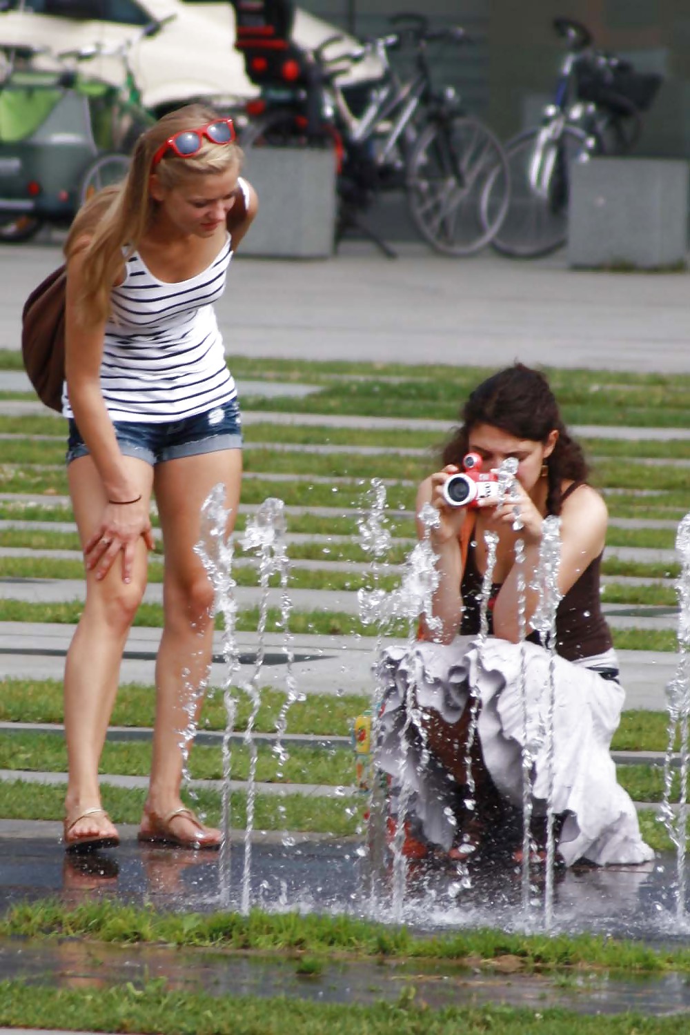 XXX two sexy and young girls takes photos on a fountain