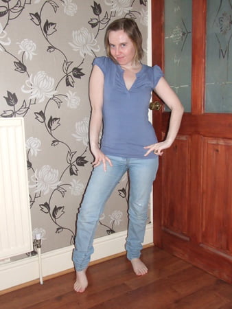 cute blonde posing in jeans and shirt         