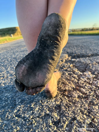torn and dirty feet in pantyhose outdoor         