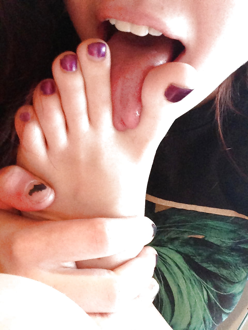 Asian girl is sucking her toes