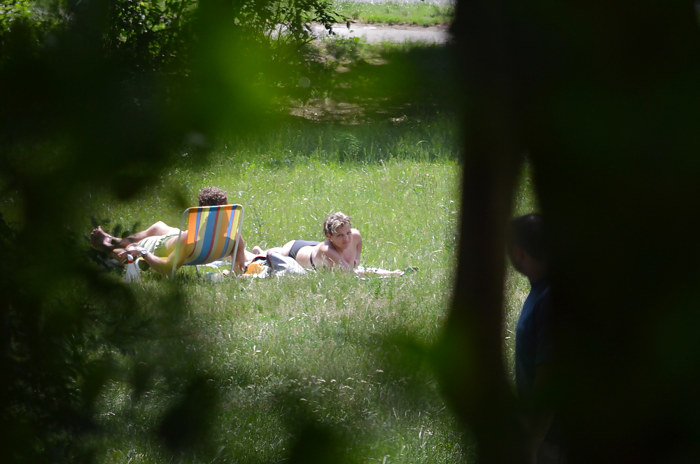 XXX girl sunbathing in the park I