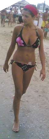 Busty chick walking on the beach